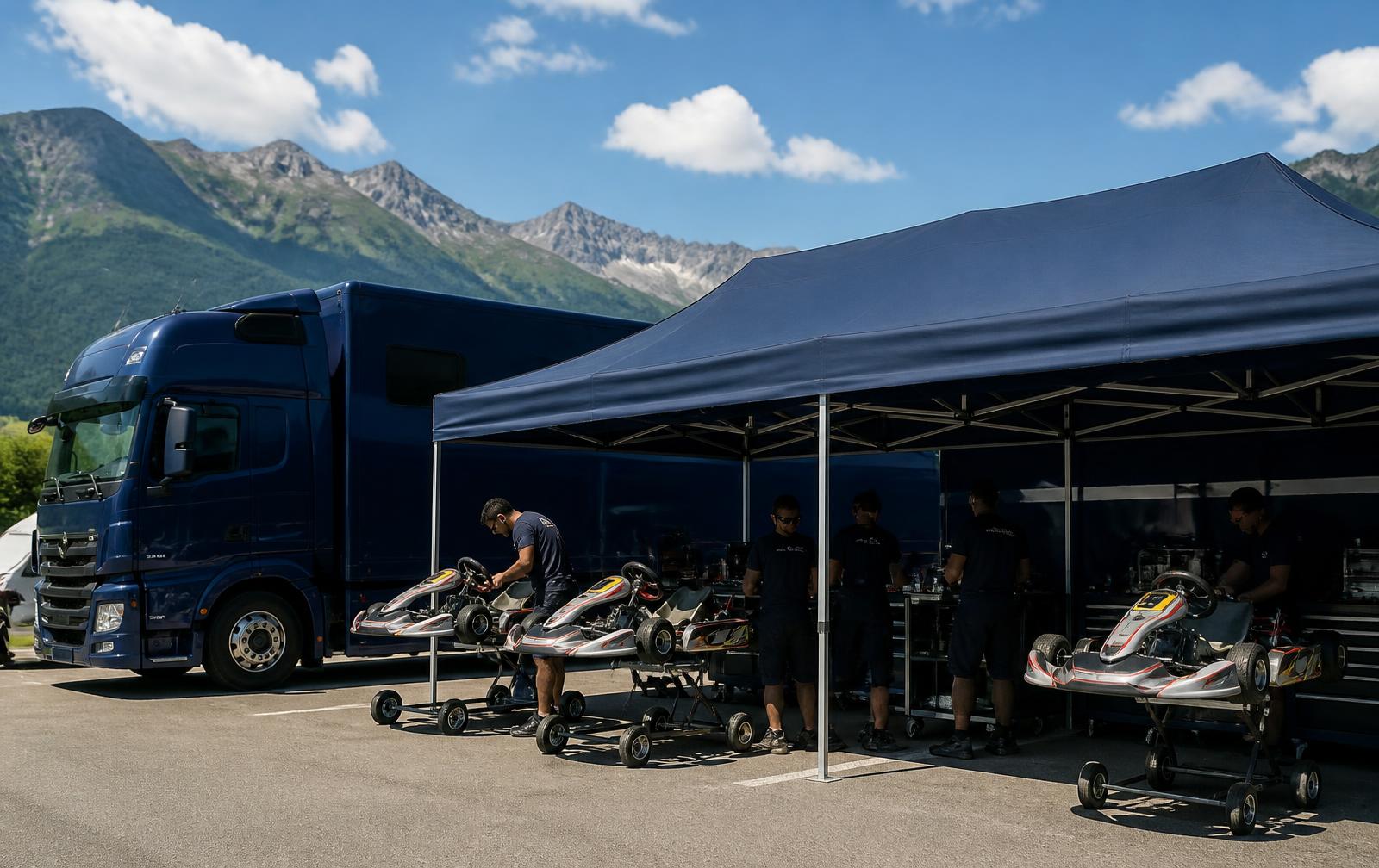 Team awning and race transporter with prepared karts in the paddock